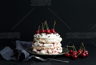 Plova cake with fresh cherry, cheese cream and chocolate chips in vintage silver plate over dark g