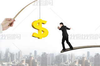Man balancing golden dollar sign fishing lure with cityscape