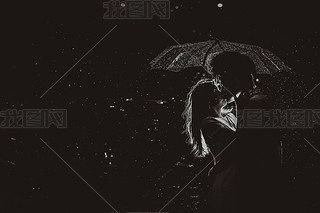 Dramatic photo of a bride and groom in the night rain.