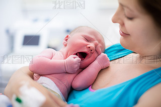 Young mother giving birth to a baby