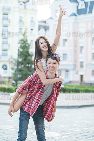 Happy young couple laughing in the city. Love Story series.