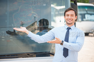 Cheerful young man is advertising a public transport
