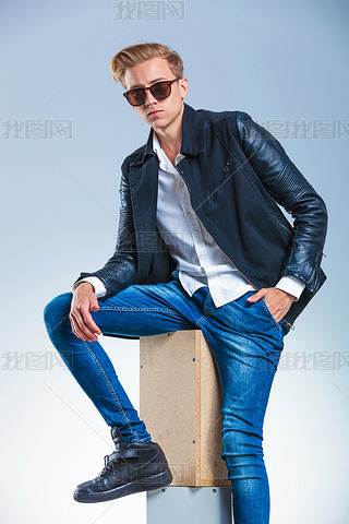 guy wearing sunglasses and leather jacket while hing his hand