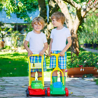 Two little boys playing with lawn mower toys