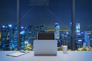 A workplace in a modern panoramic office with New York evening view. A white table, black leather ch