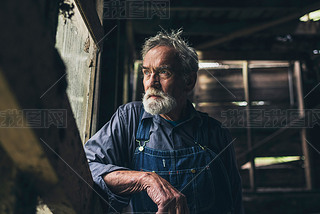 Elderly man staring out of window