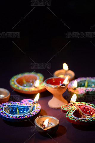 Colorful clay Diya (Lantern) lamps lit during Diwali celebration. Greetings Card Design Indian Hindu