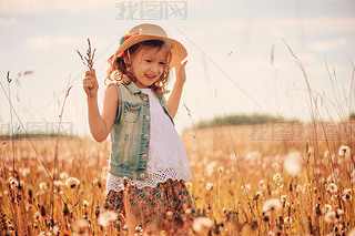 happy child on summer field, spending vacation outdoor, warm rural scene