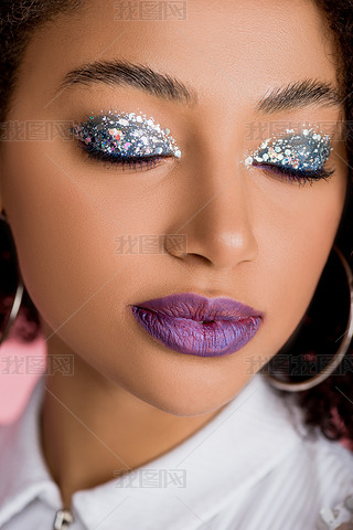african american girl with silver glitter eyeshadows on closed eyes and purple lips, isolated on pin