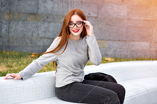 young beautiful woman in stylish glasses  posing on street 