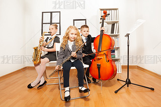 Happy kids playing musical instruments