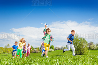 Running boy with airplane toy and children