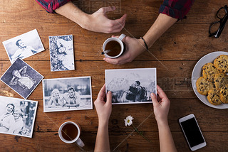 Mans and womans hands. Black-and-white photos. le. Tea, cookies, phone.