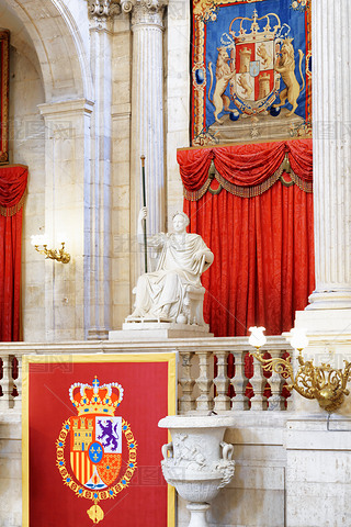 The coat of arms of the King of Spain and a sculpture in the int
