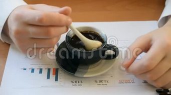 商人在桌上的一小杯咖啡里干扰糖